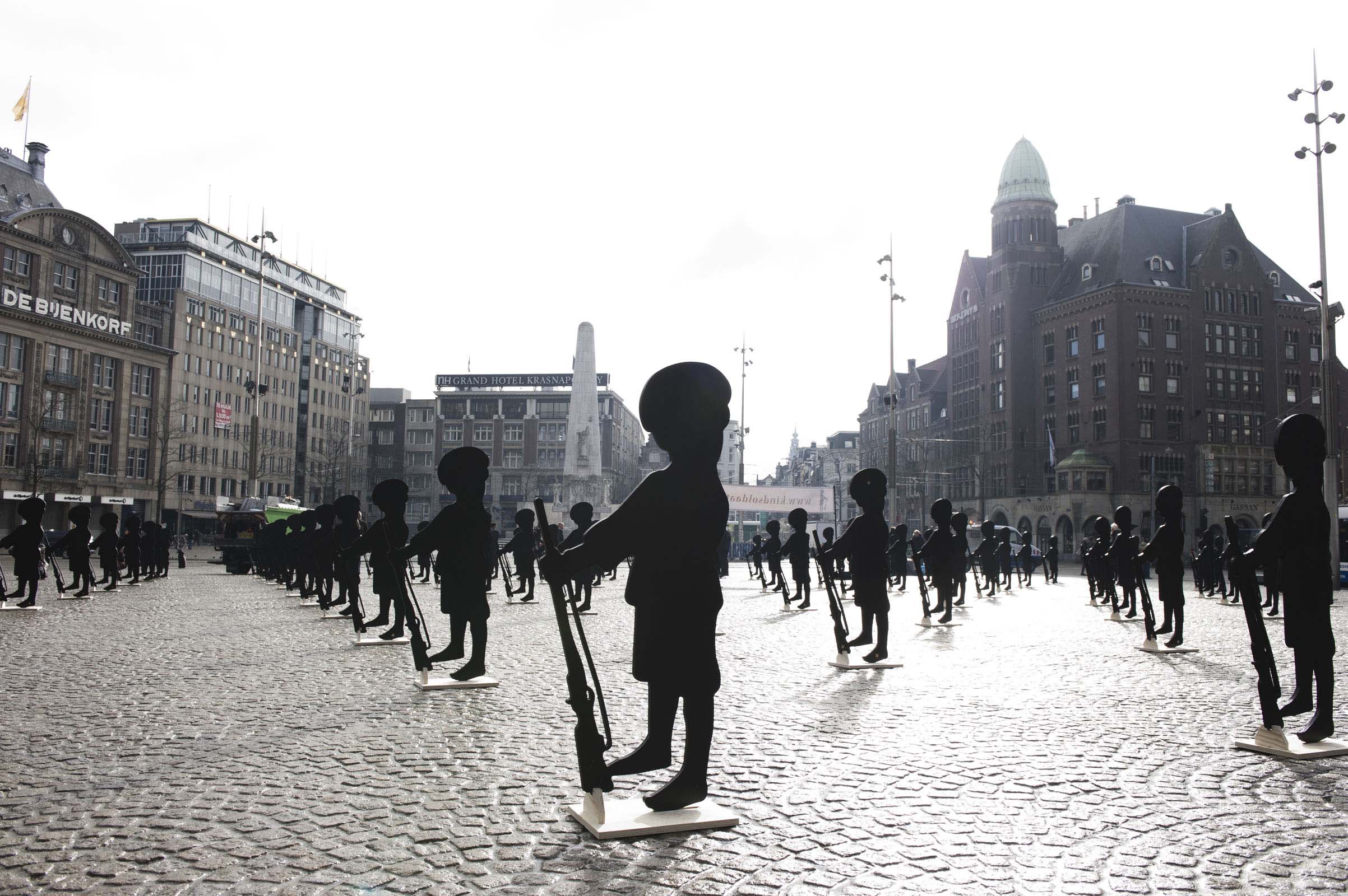 Dam Square of Amsterdam filled with army of child soldier puppets designed by Claudia Hansen